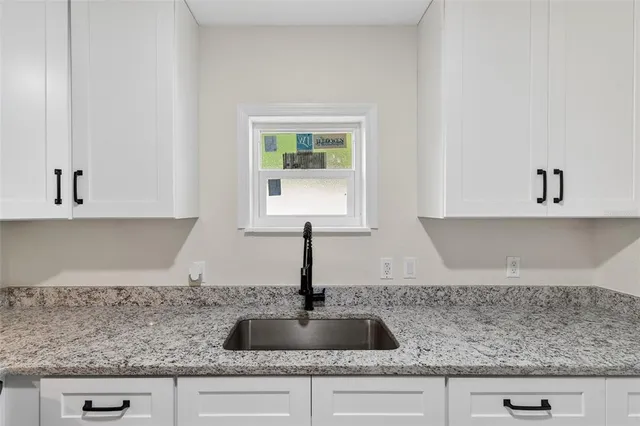 a kitchen with stainless steel appliances granite countertop a sink and a stove