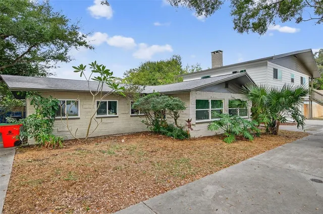 a front view of a house with a yard and a garage