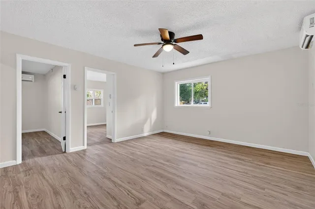wooden floor in an empty room with a window