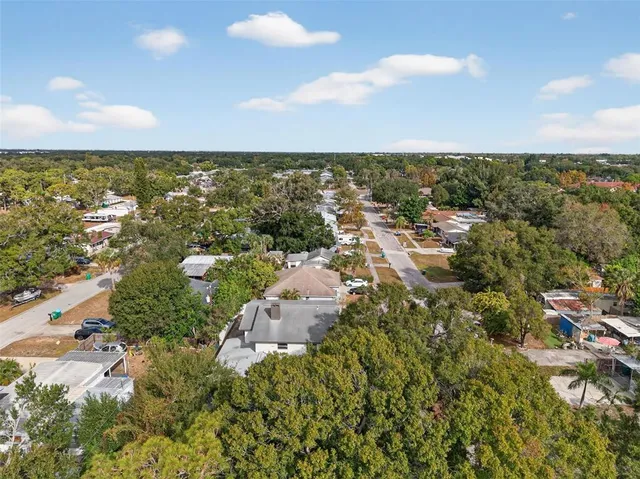 an aerial view of residential building with green space