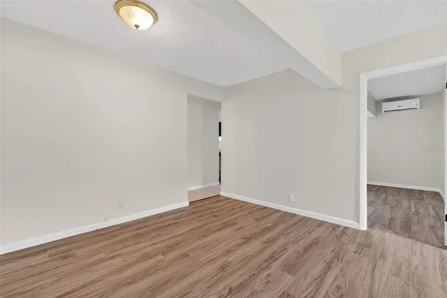 a view of a room with wooden floor