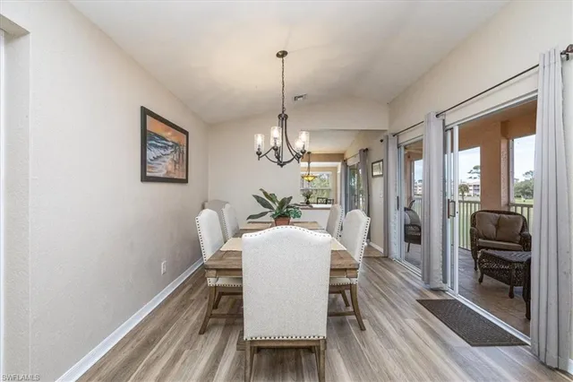 a dining room with furniture wooden floor a chandelier