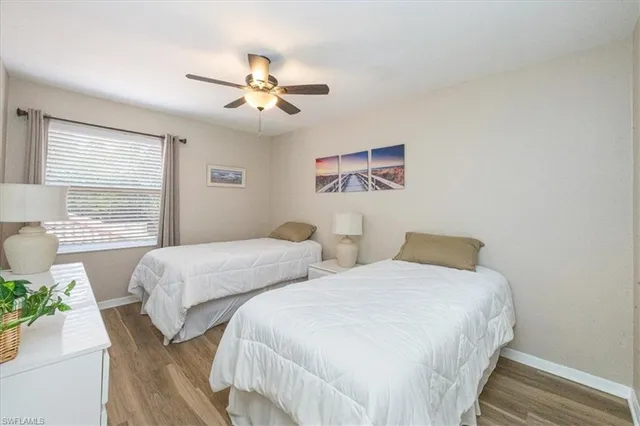 a bedroom with two beds and a chandelier