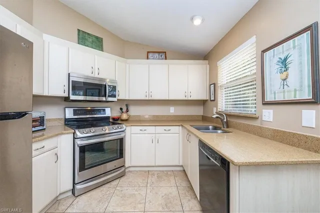a kitchen with stainless steel appliances granite countertop a sink stove and microwave