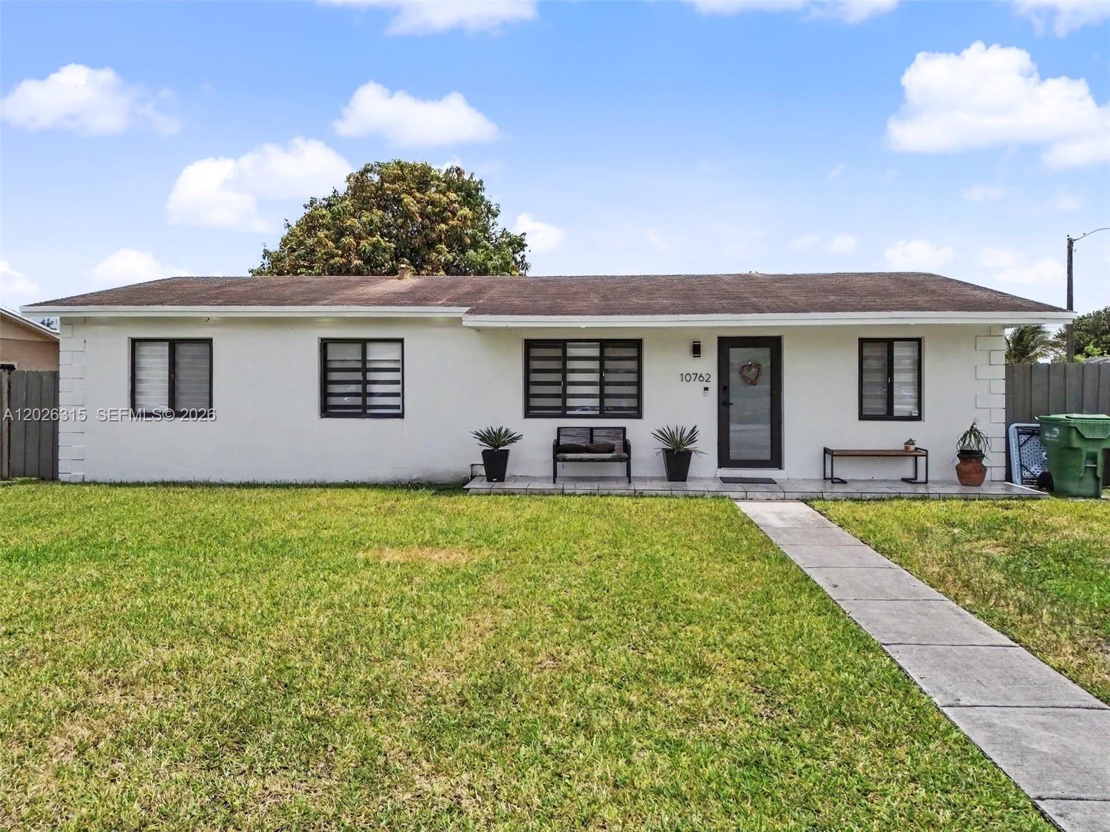 10762 Southwest 145th Street Miami, FL 33176 - Photo 1 of 28 a house view with a garden space