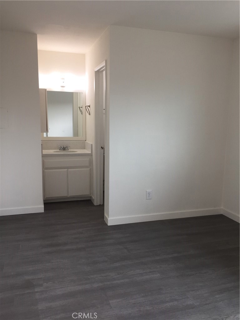 17011 Sims Lane, Unit 6 Huntington Beach, CA 92649 - Photo 11 of 19 a view of cabinets and wooden floor