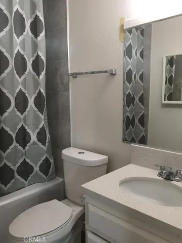 a white toilet sitting next to a bathroom sink