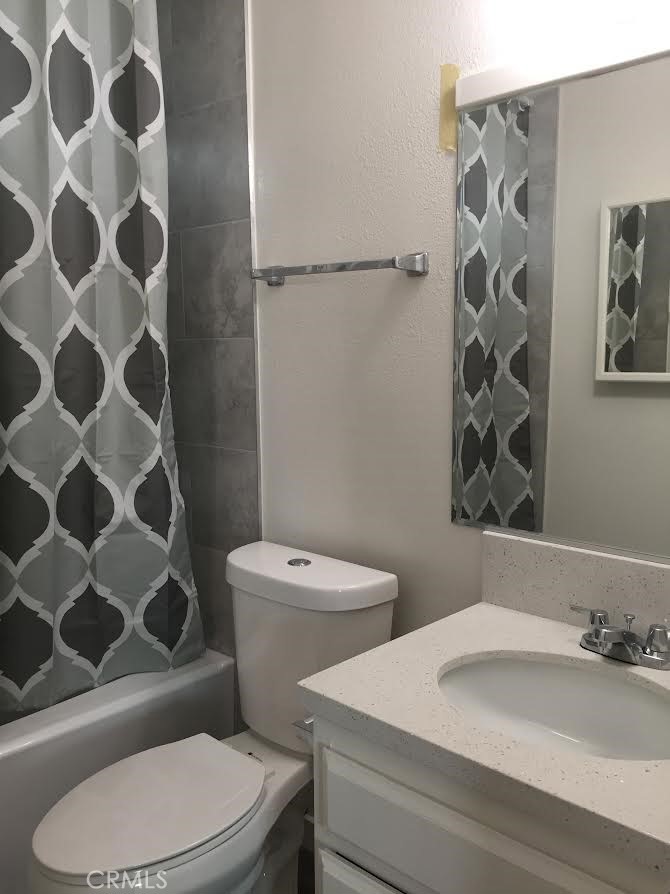 17011 Sims Lane, Unit 6 Huntington Beach, CA 92649 - Photo 15 of 19 a white toilet sitting next to a bathroom sink