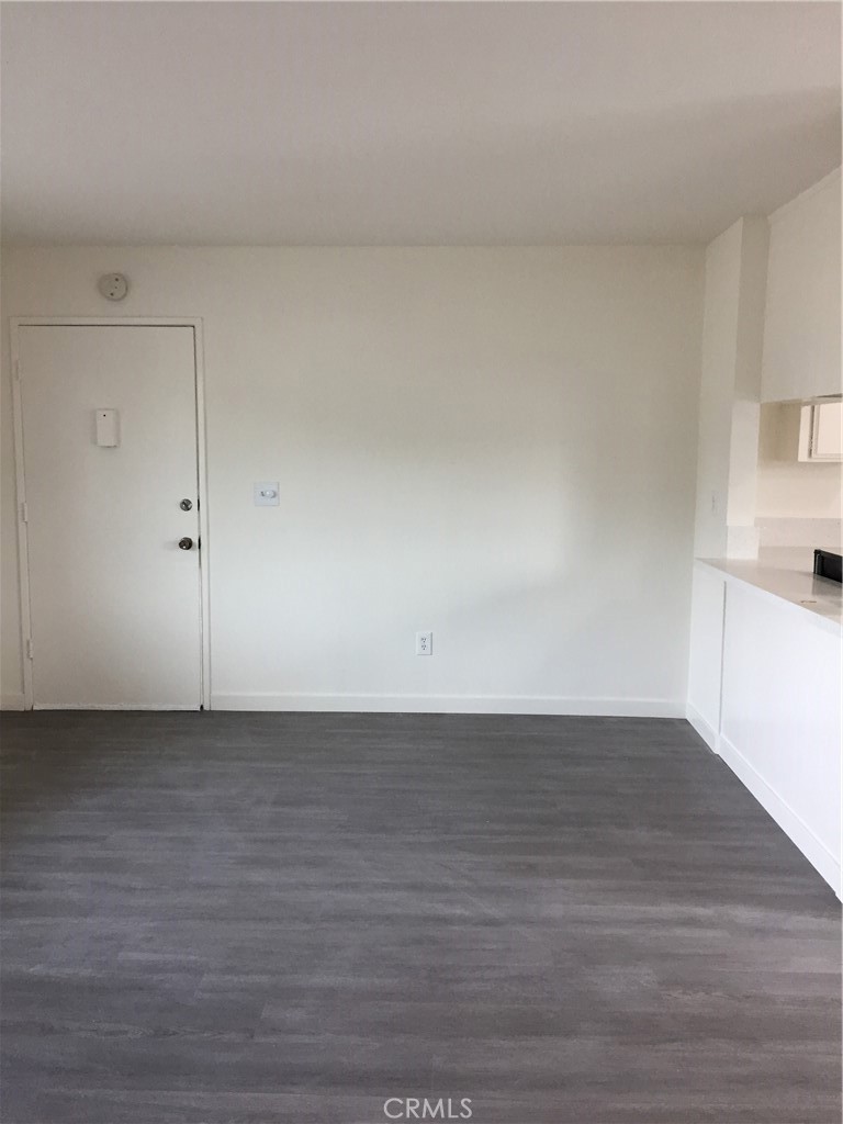 17011 Sims Lane, Unit 6 Huntington Beach, CA 92649 - Photo 2 of 19 a view of a room with wooden floor