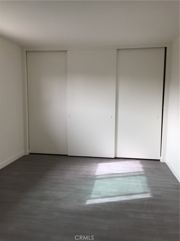 17011 Sims Lane, Unit 6 Huntington Beach, CA 92649 - Photo 10 of 19 a view of an empty room and wooden floor