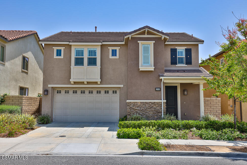 13988 Burdock Drive Moorpark, CA 93021 - Photo 1 of 35 a front view of a house with a yard and garage
