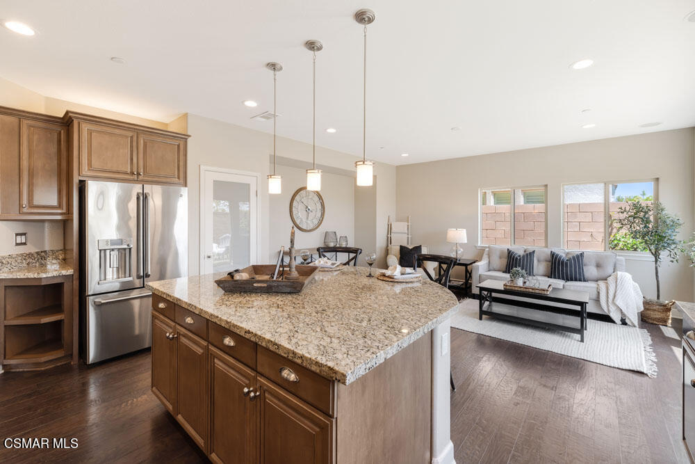 13988 Burdock Drive Moorpark, CA 93021 - Photo 12 of 35 a open kitchen with stainless steel appliances granite countertop a sink a stove and a refrigerator