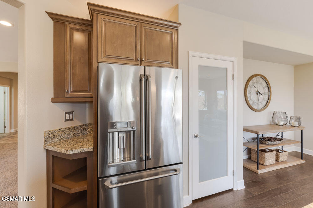 13988 Burdock Drive Moorpark, CA 93021 - Photo 13 of 35 a kitchen with stainless steel appliances granite countertop a refrigerator and a stove with wooden floor