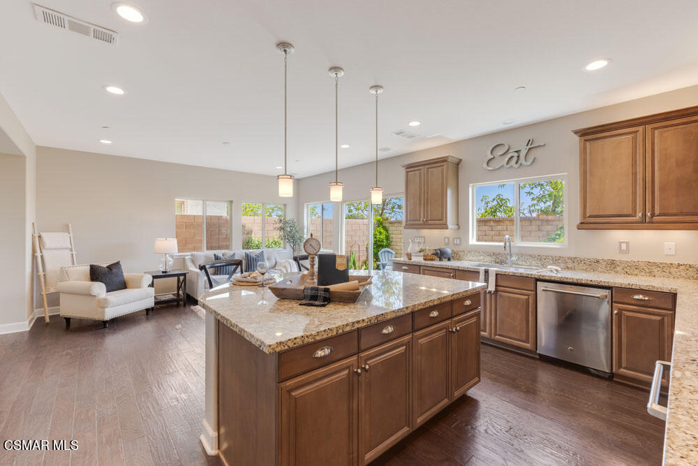 13988 Burdock Drive Moorpark, CA 93021 - Photo 14 of 35 a large kitchen with stainless steel appliances granite countertop a stove and a wooden floors