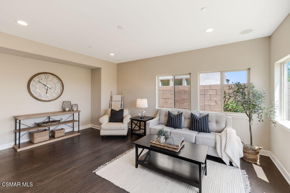 13988 Burdock Drive Moorpark, CA 93021 - Photo 15 of 35 a living room with furniture a large window and a clock
