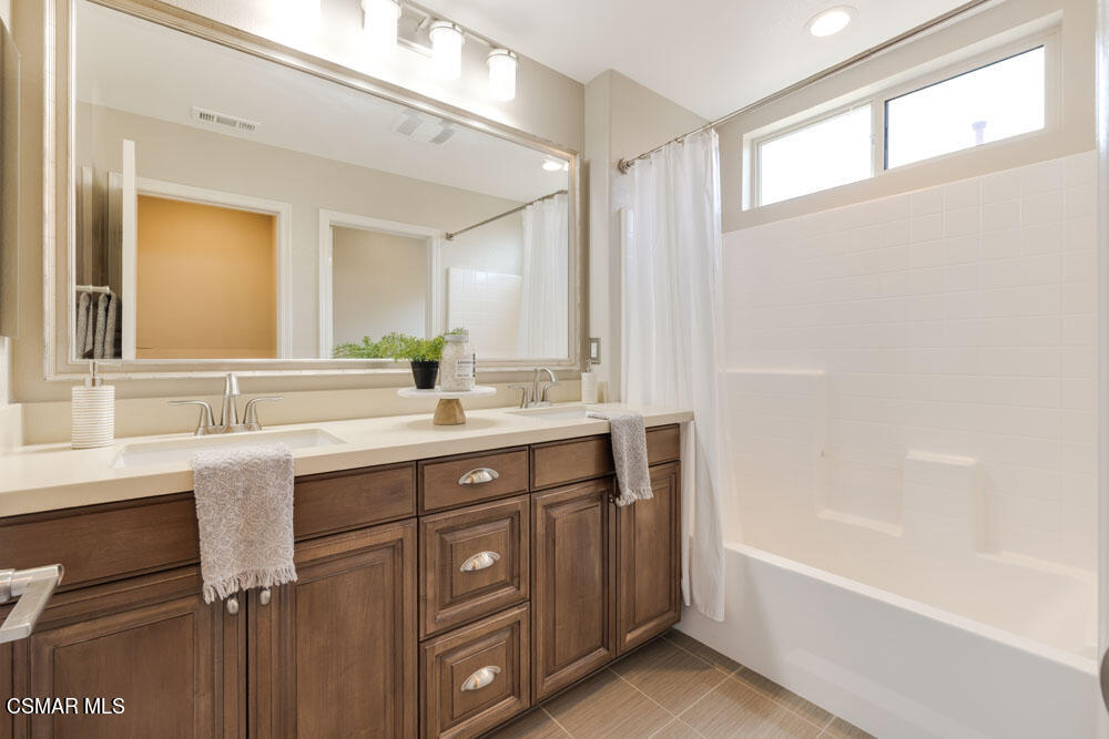 13988 Burdock Drive Moorpark, CA 93021 - Photo 17 of 35 a bathroom with a tub sink and mirror