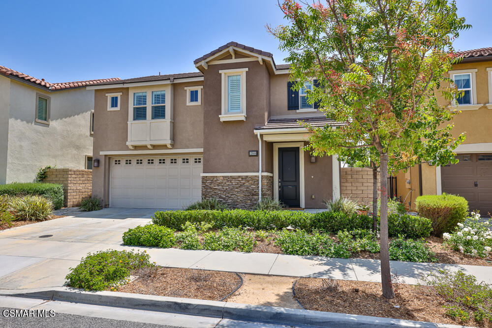 13988 Burdock Drive Moorpark, CA 93021 - Photo 2 of 35 a front view of a house with plants and trees