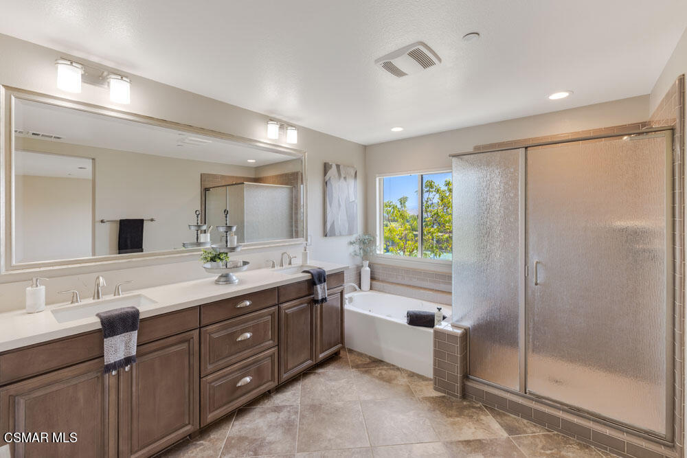 13988 Burdock Drive Moorpark, CA 93021 - Photo 22 of 35 a spacious bathroom with a granite countertop sink mirror and shower