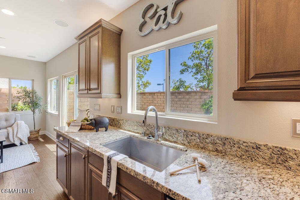 13988 Burdock Drive Moorpark, CA 93021 - Photo 28 of 35 a kitchen with a sink a stove and a wooden floor