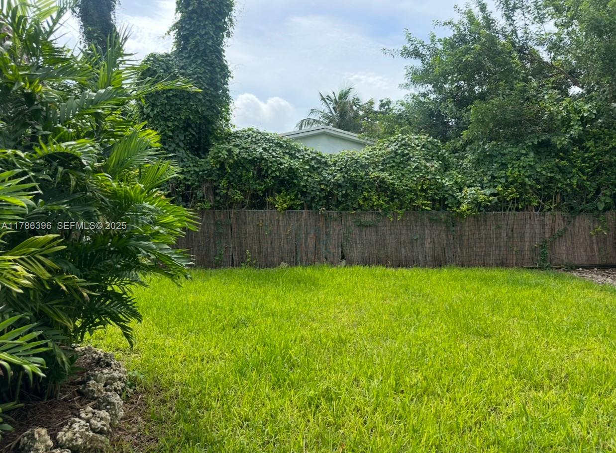 29035 Maine Road Homestead, FL 33033 - Photo 13 of 55 a view of a backyard with large trees and wooden fence