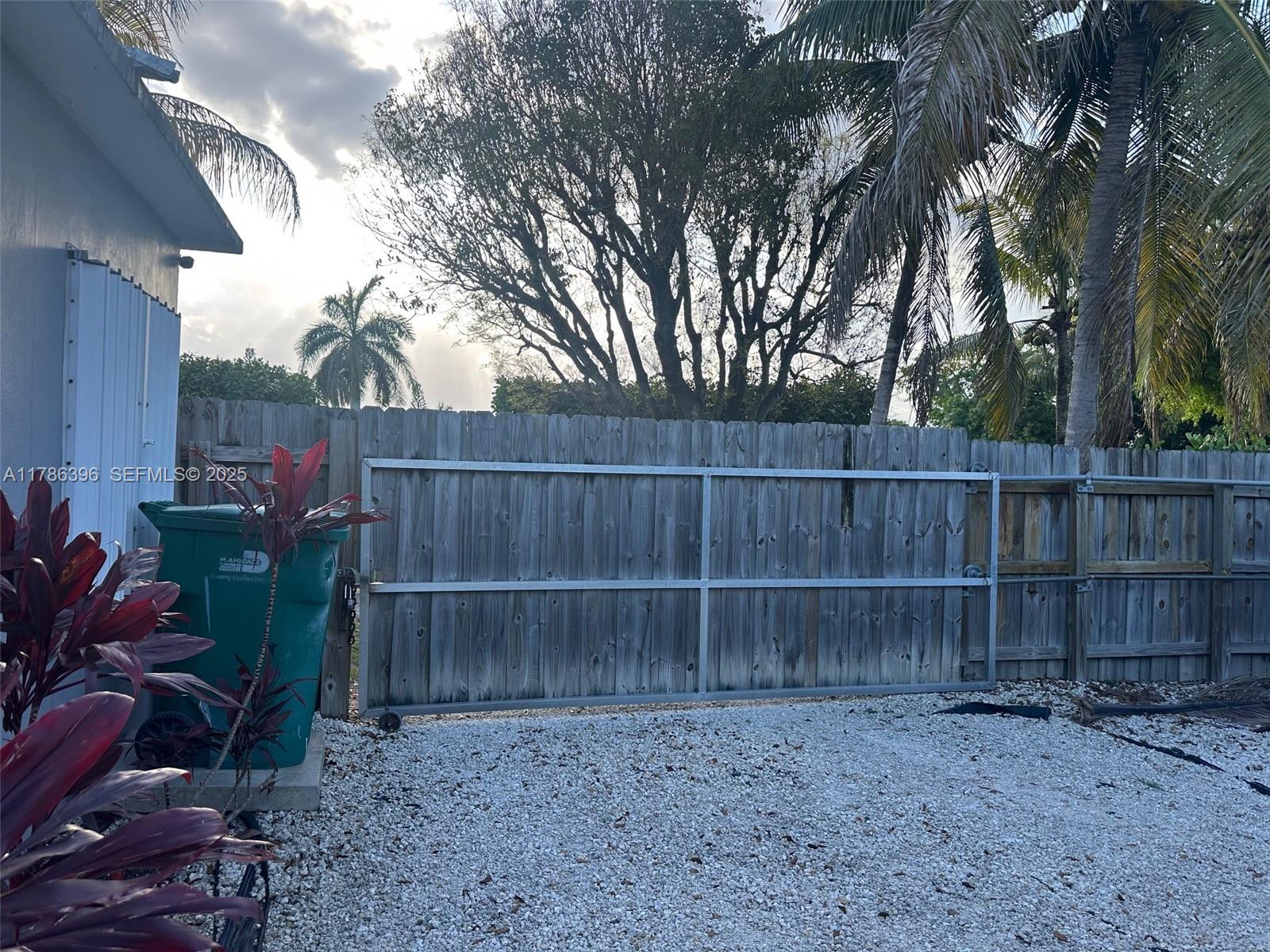 29035 Maine Road Homestead, FL 33033 - Photo 19 of 55 a view of a backyard with wooden fence