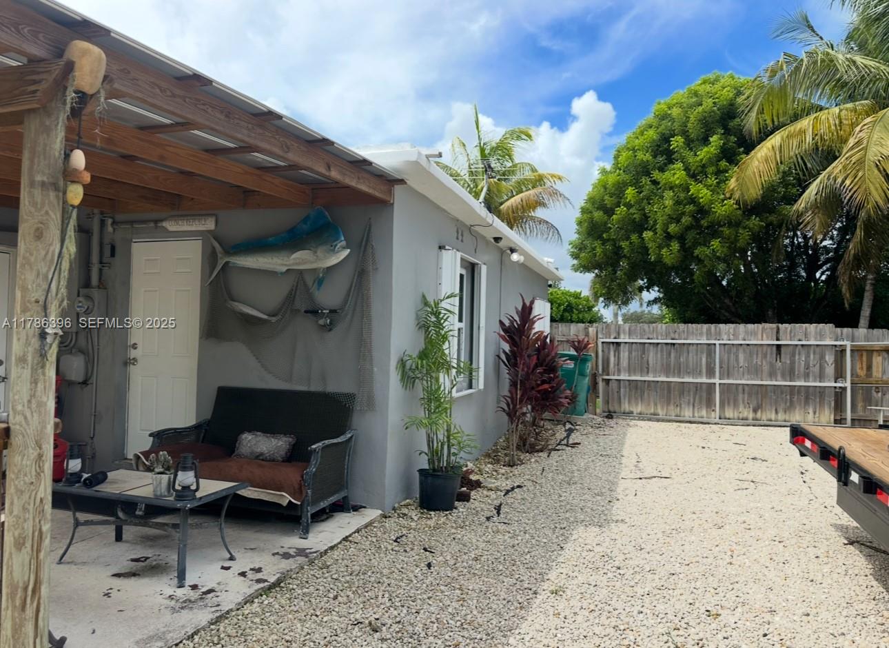 29035 Maine Road Homestead, FL 33033 - Photo 20 of 55 a view of a porch with furniture and floor to ceiling window