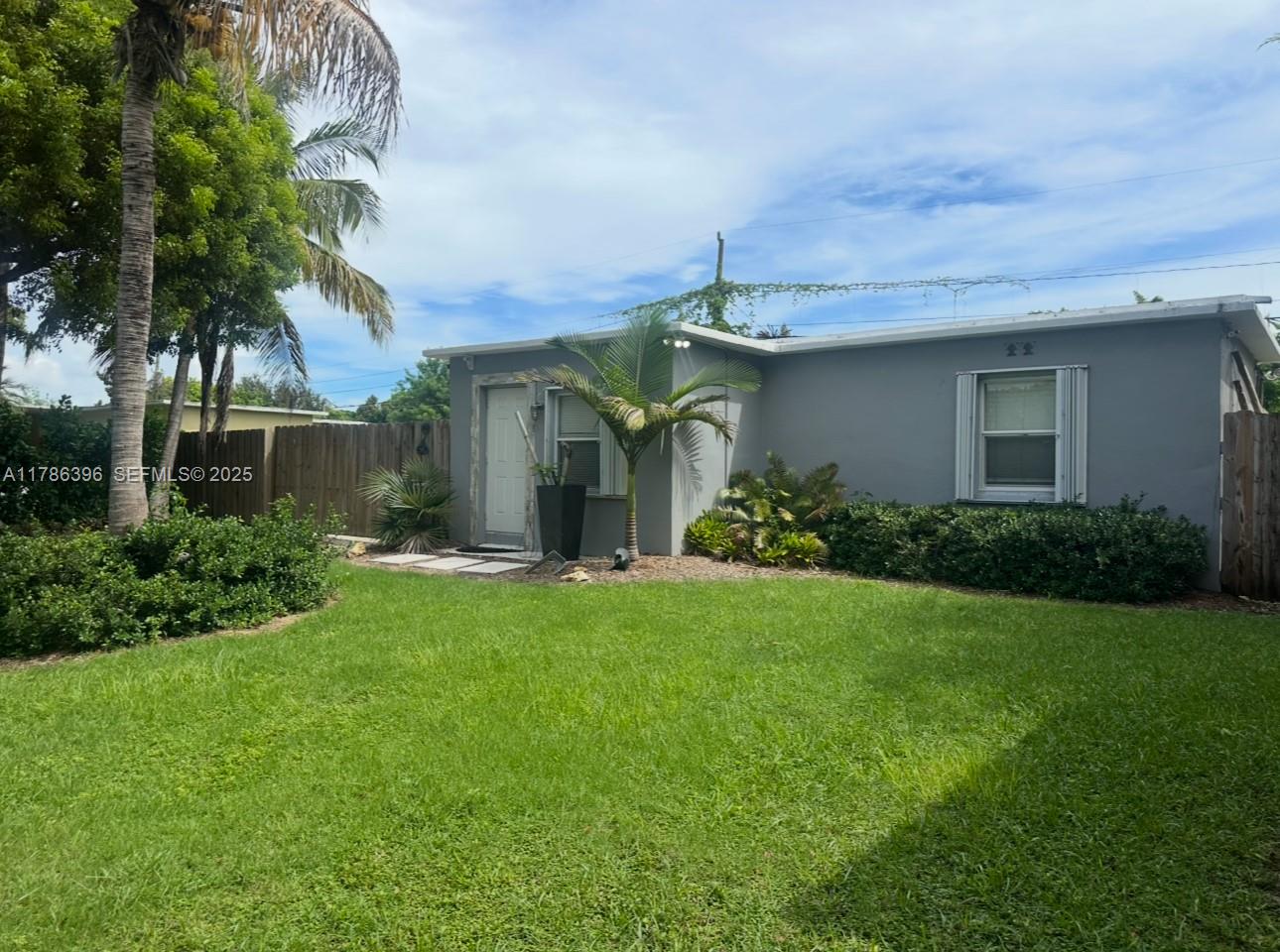 29035 Maine Road Homestead, FL 33033 - Photo 2 of 55 a front view of a house with garden
