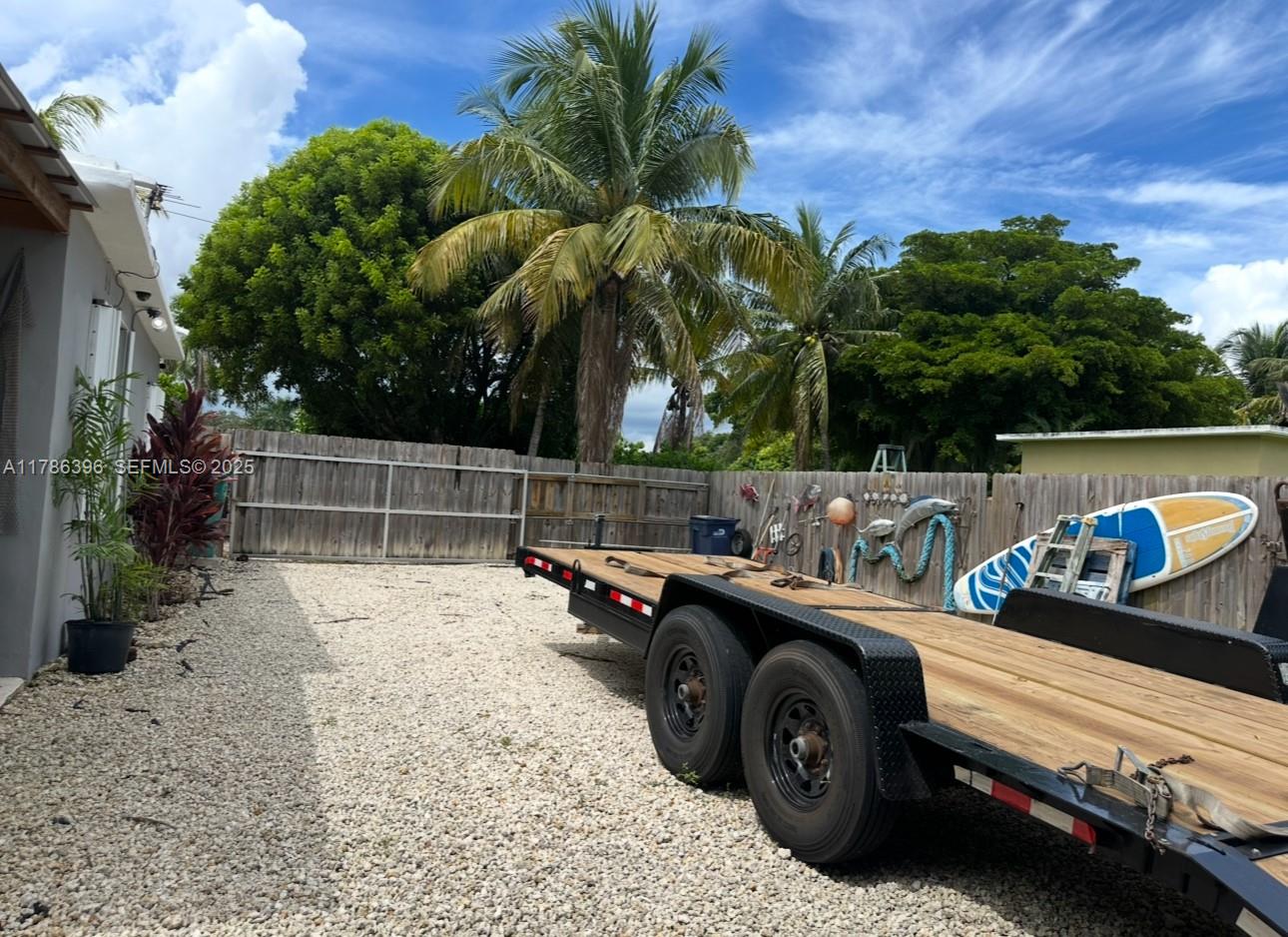 29035 Maine Road Homestead, FL 33033 - Photo 21 of 55 a view of a backyard with a car and trees