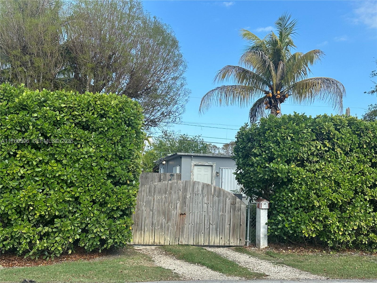 29035 Maine Road Homestead, FL 33033 - Photo 3 of 55 a view of a house with a yard and potted plants