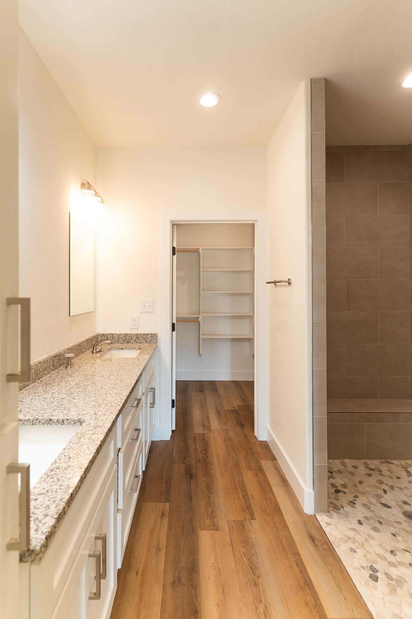 309 String Prairie Way Smithville, TX 78957 - Photo 18 of 30 a bathroom with a granite countertop sink and a shower