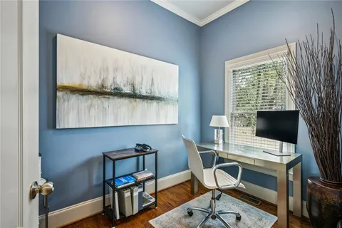 a view of a workspace with furniture and a window