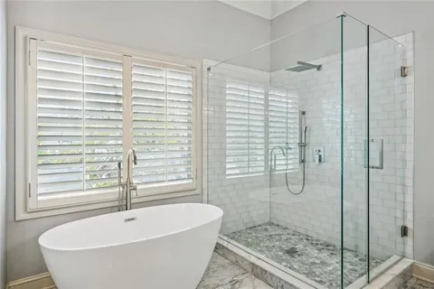 a bathroom with a bathtub and shower