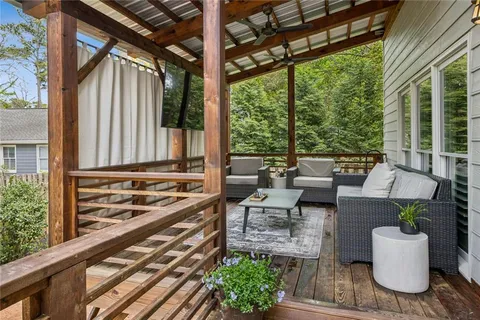 a view of a patio with couches table and chairs and potted plants