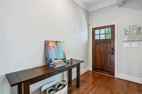a view of a workspace with furniture and wooden floor