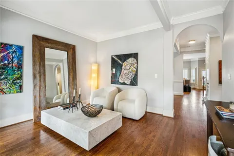 a living room with furniture and a wooden floor