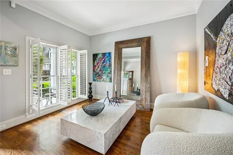 a living room with furniture and a floor to ceiling window