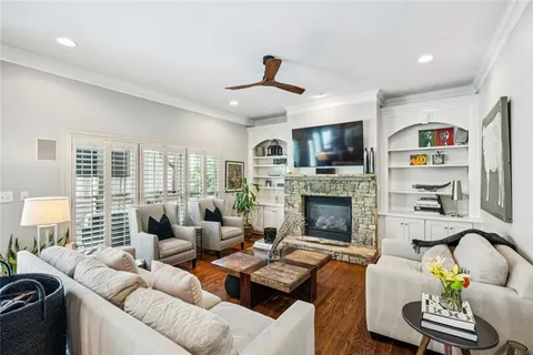 a living room with furniture fireplace and flat screen tv
