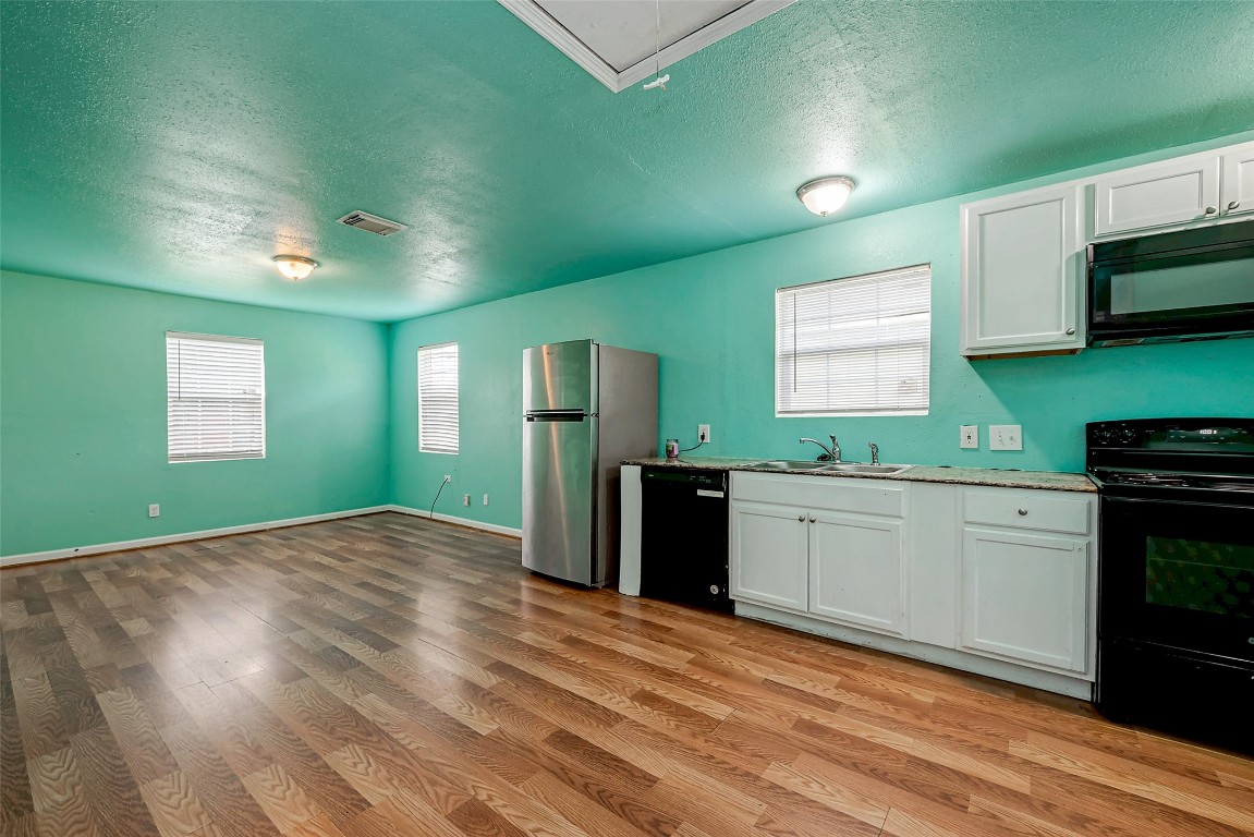 3938 King Street Houston, TX 77026 - Photo 28 of 34 a kitchen with kitchen island a counter top space appliances and a sink