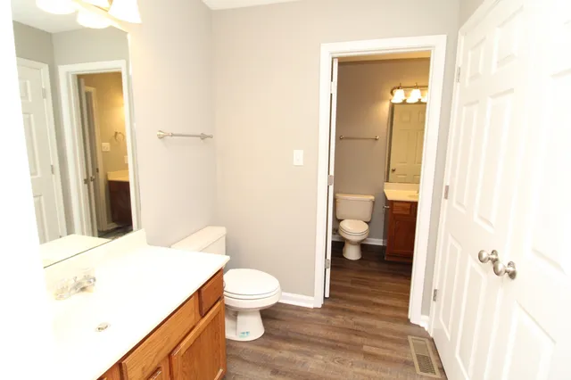 a bathroom with a toilet and a view of bathroom