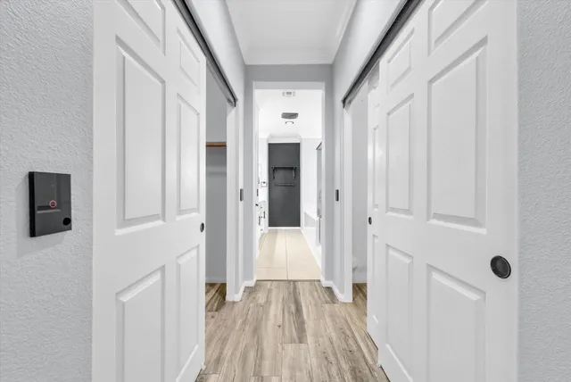 a view of a hallway with wooden floor and staircase