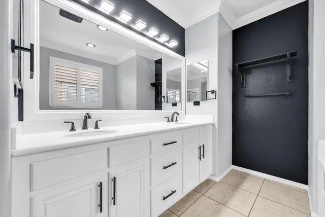 a bathroom with a double vanity sink a and a mirror