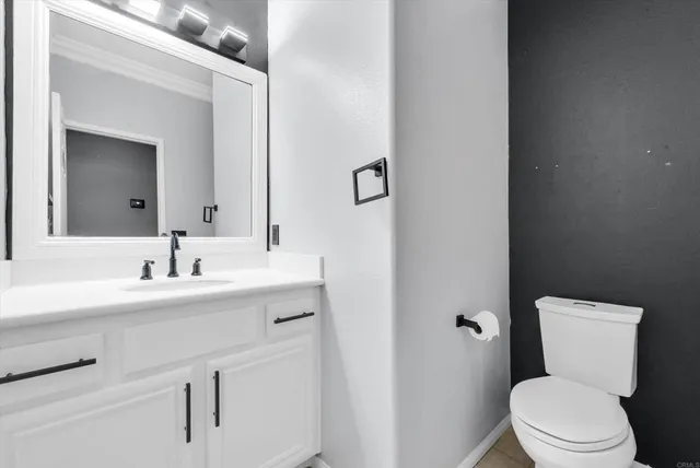 a bathroom with a toilet a sink and mirror