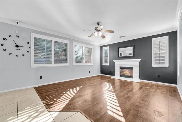 a view of an empty room with a fireplace and a window