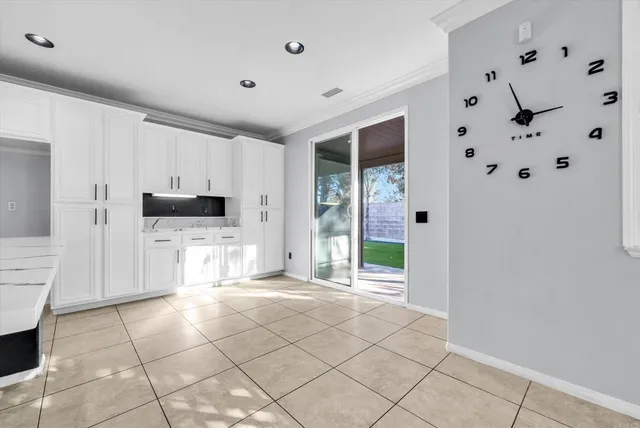 a view of a electric appliances and cabinets in a room