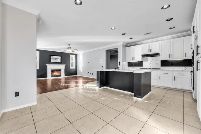 a kitchen with stainless steel appliances kitchen island granite countertop a refrigerator and cabinets
