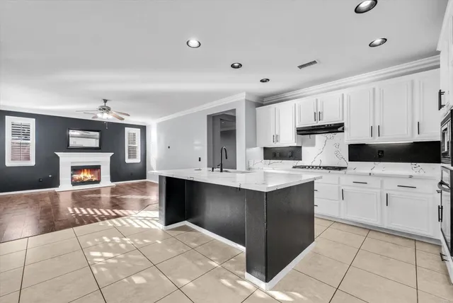 a kitchen with stainless steel appliances kitchen island granite countertop a sink and cabinets