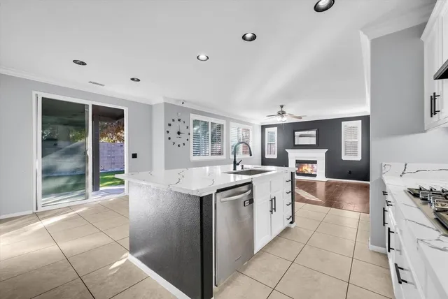 a kitchen with stainless steel appliances granite countertop a sink and cabinets