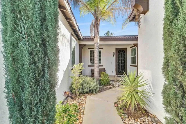 a front view of a house with a garden