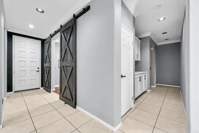 a view of hallway with stairs and a refrigerator