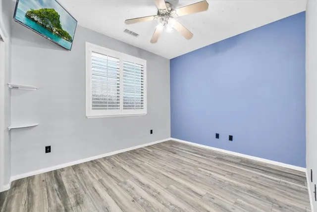 a view of room with window and ceiling fan